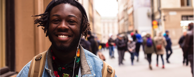 Student smiling on the street.