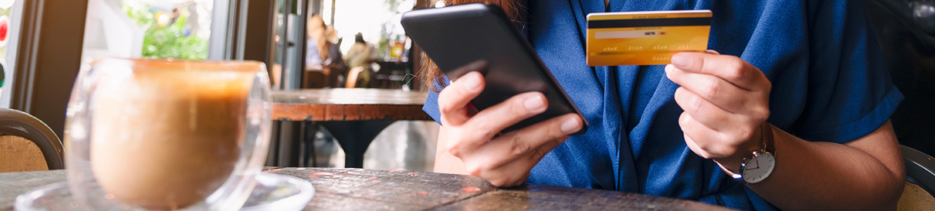 woman with card and phone in her hands