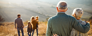 older couple looking at family in the distance