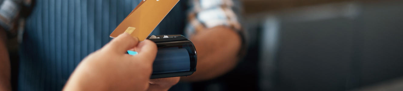 a person using a debit card at store.