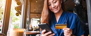 woman with card and phone in her hands